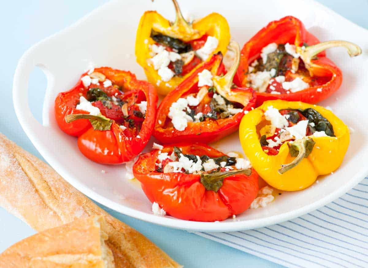 Tomato basil stuffed peppers with garlic, fresh basil, and crumbled cheese
