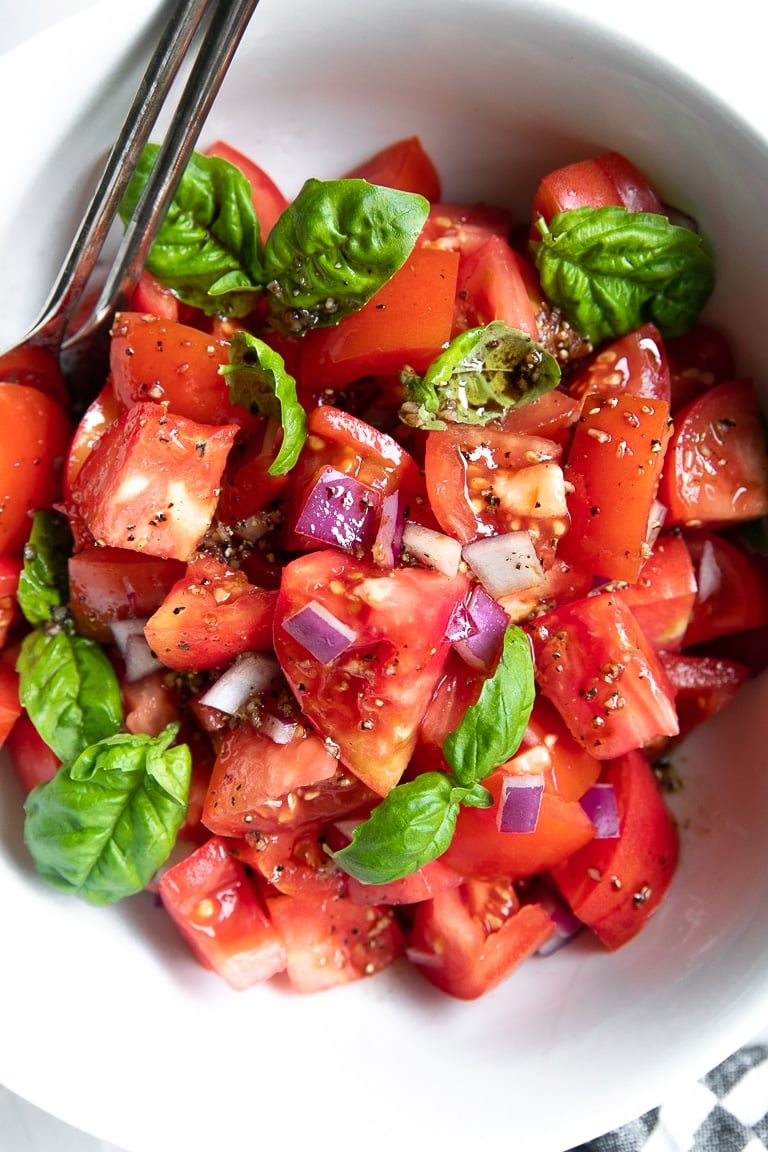 Tomato basil salad with heirloom tomatoes, red onion, and fresh basil