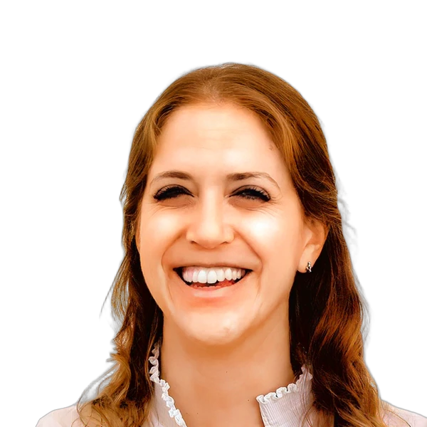Smiling woman with wavy hair wearing a ruffled collar blouse against a white background.