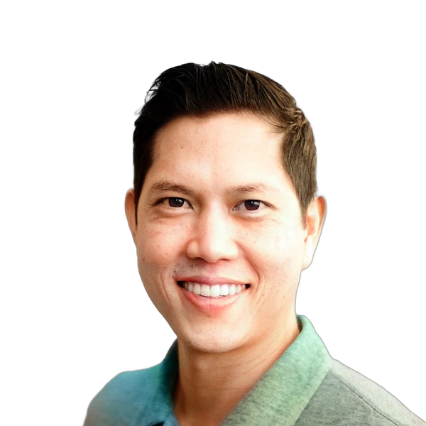 Smiling man with short dark hair wearing a collared shirt against a white background.