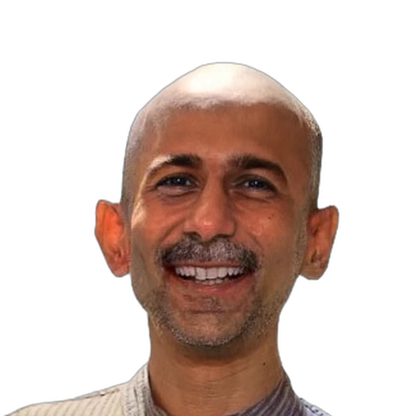 Smiling bald man with mustache and trimmed beard wearing a striped collared shirt.