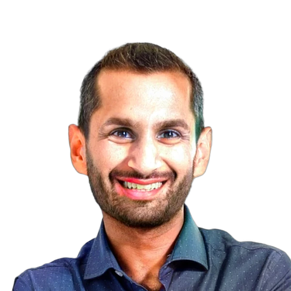 Smiling man with short hair and beard wearing a dark shirt against a white background.