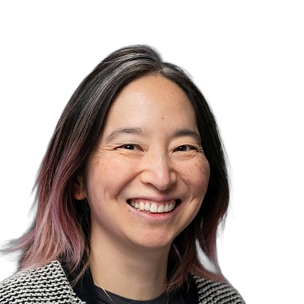 Headshot of a smiling woman with straight hair wearing a blazer.