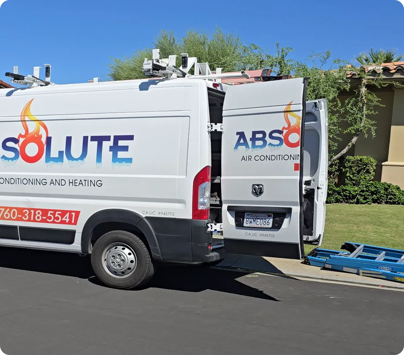 White service van with partial logo 'Absolute Air Conditioning and Heating' and an open rear door next to a blue ladder on a driveway.