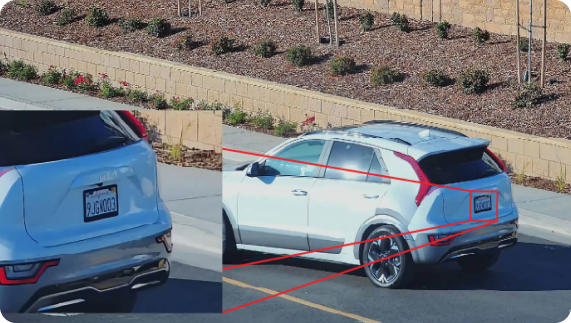 An SUV driving on a road. A call out box on the side shows a close up of a license plate.