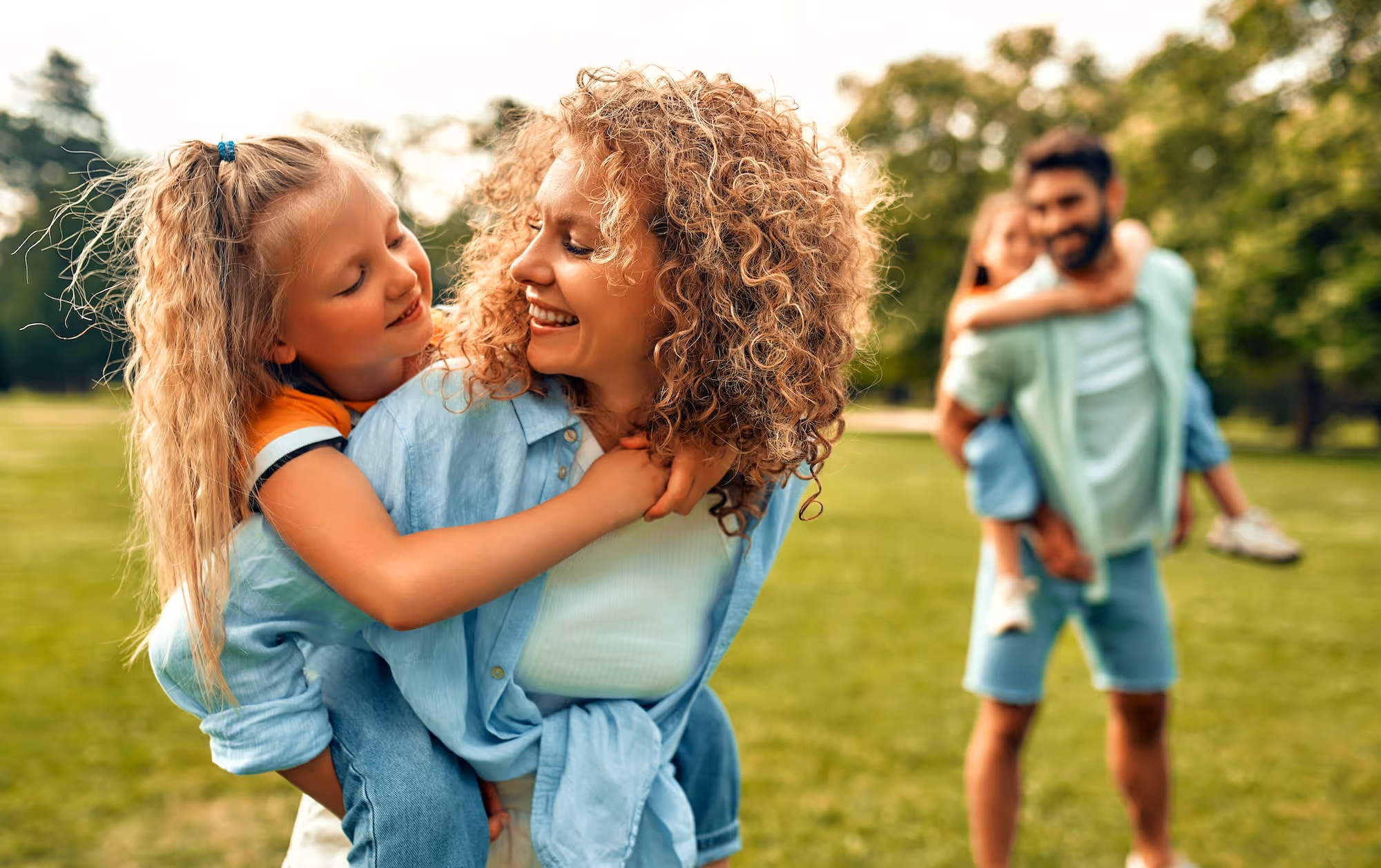 Smiling family playing together in the park.