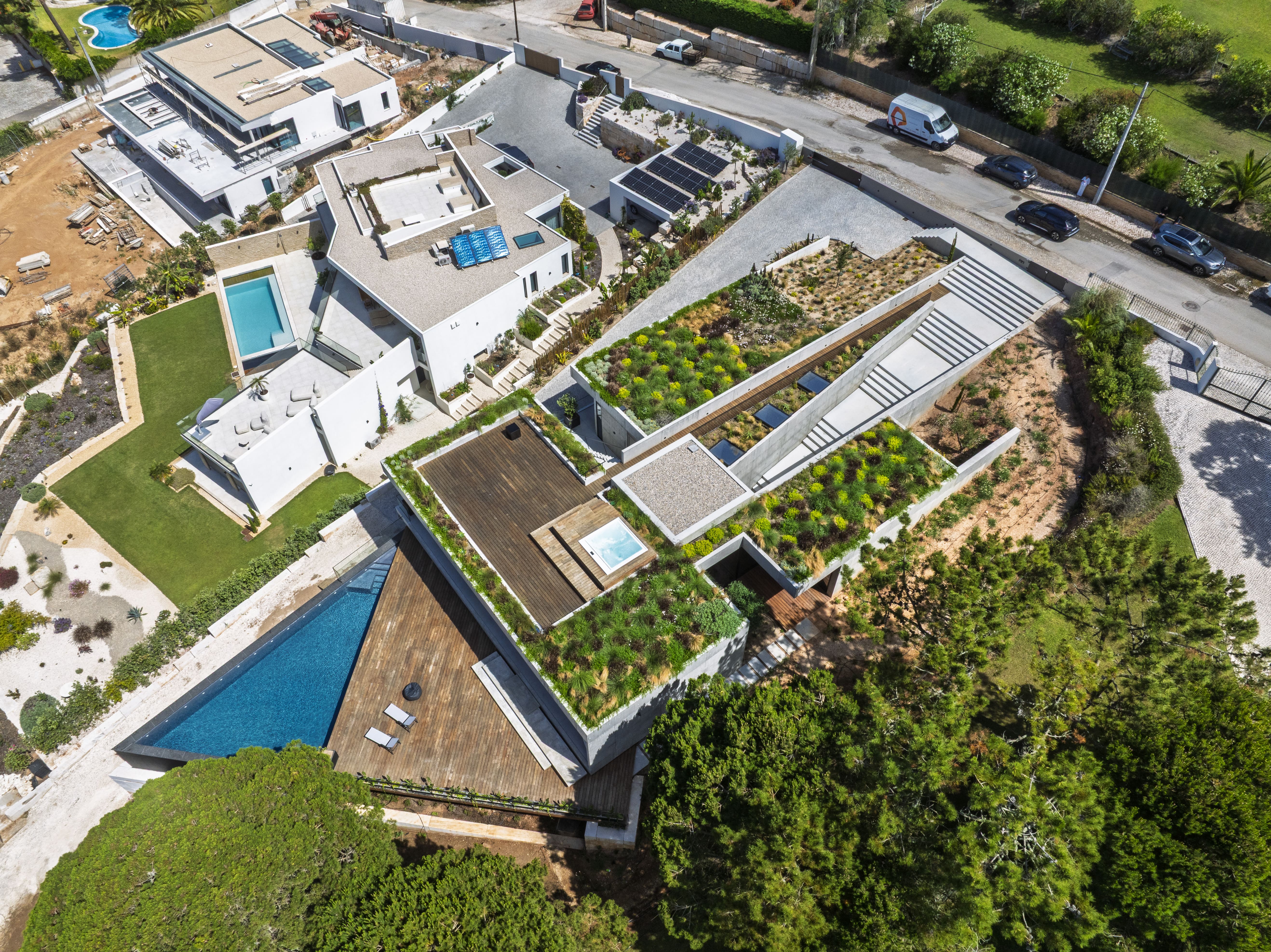 Triangular Hillside Villa aerial showing wood and concrete facade integration with landscape