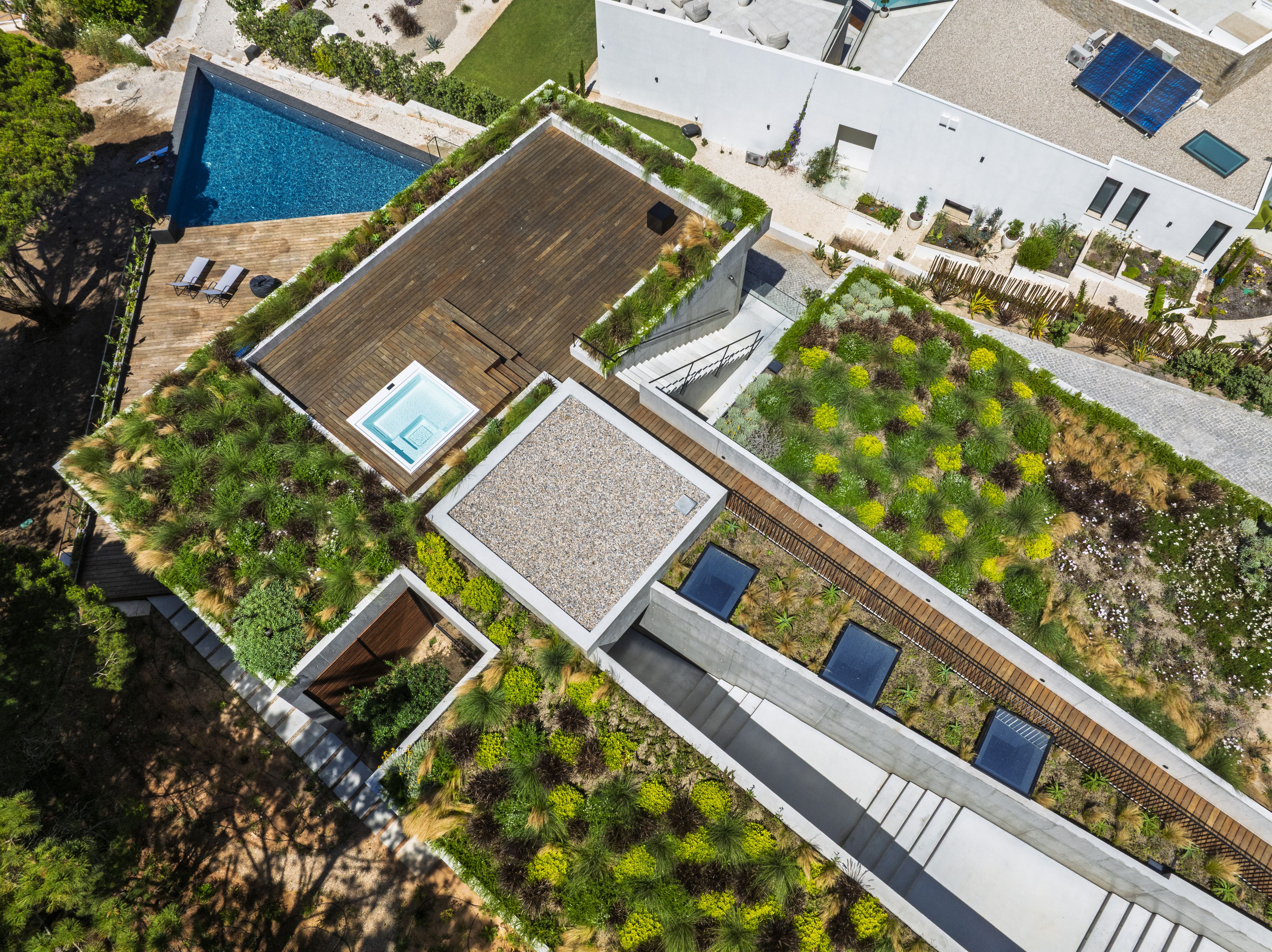 Triangular Hillside Villa drone shot showing angular triangular pool and wood deck terrace