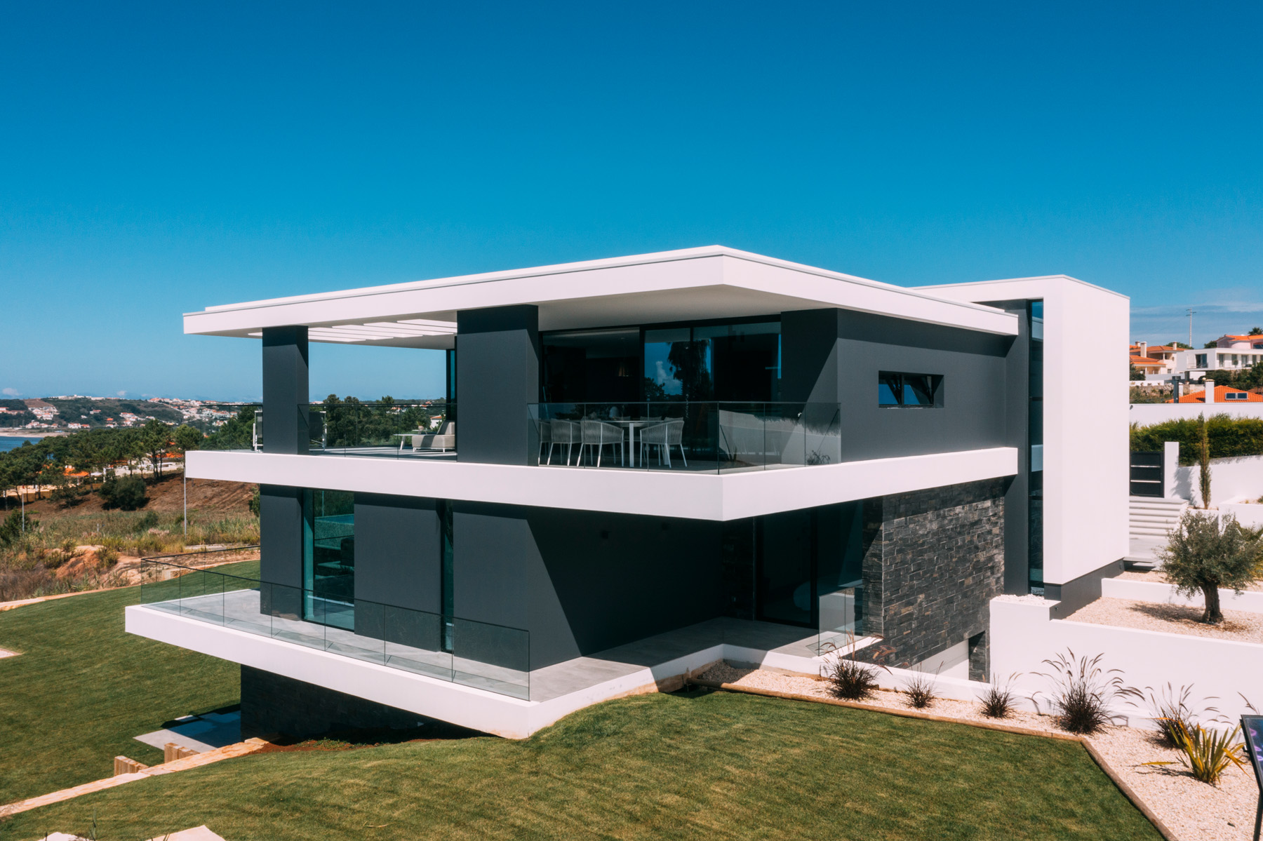 Sea Insight Villa interior open-plan living space with floor-to-ceiling glass and sea views