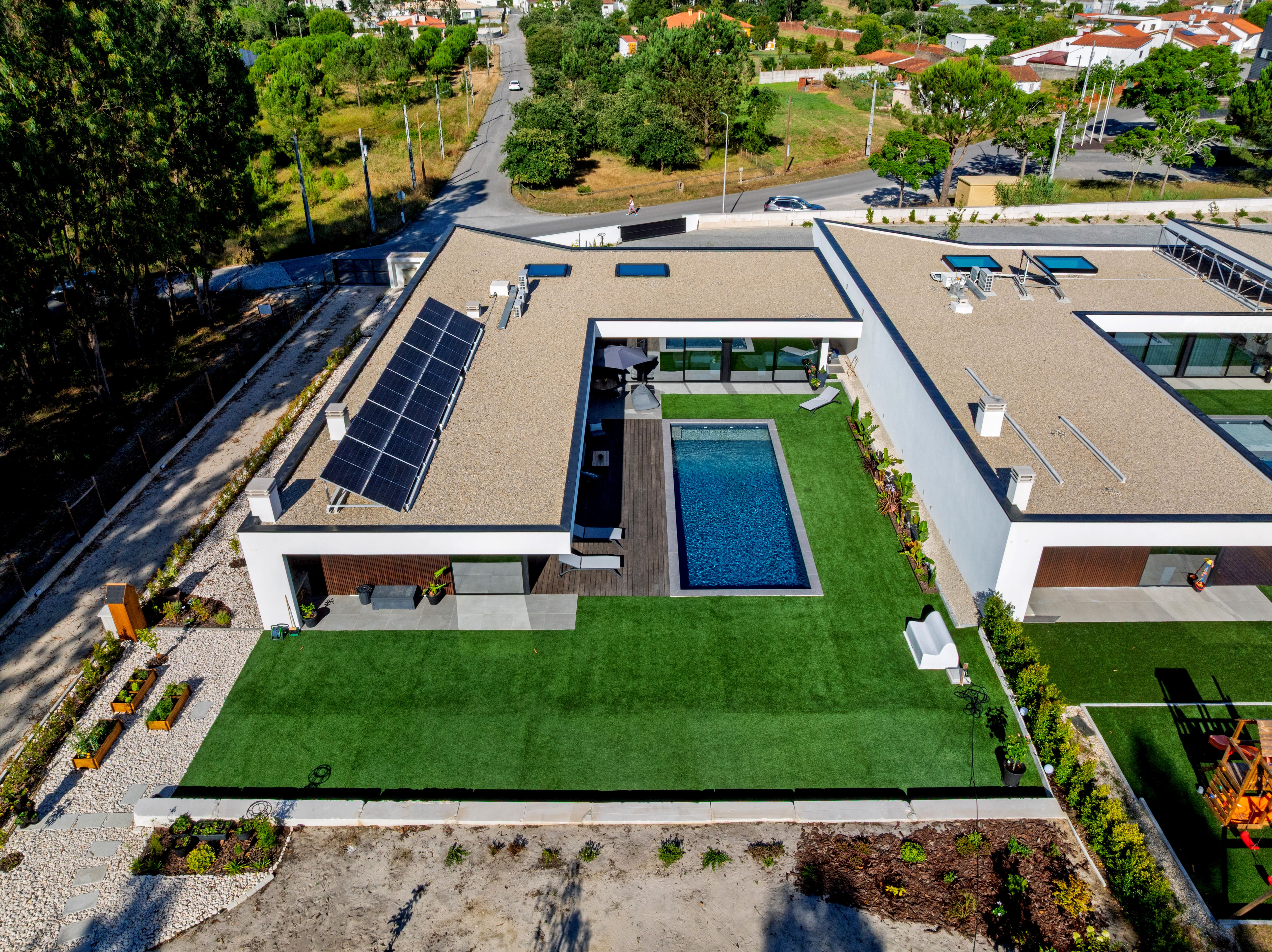 Kings Woodland Condominium drone photo showing bamboo-clad villa facades and private gardens