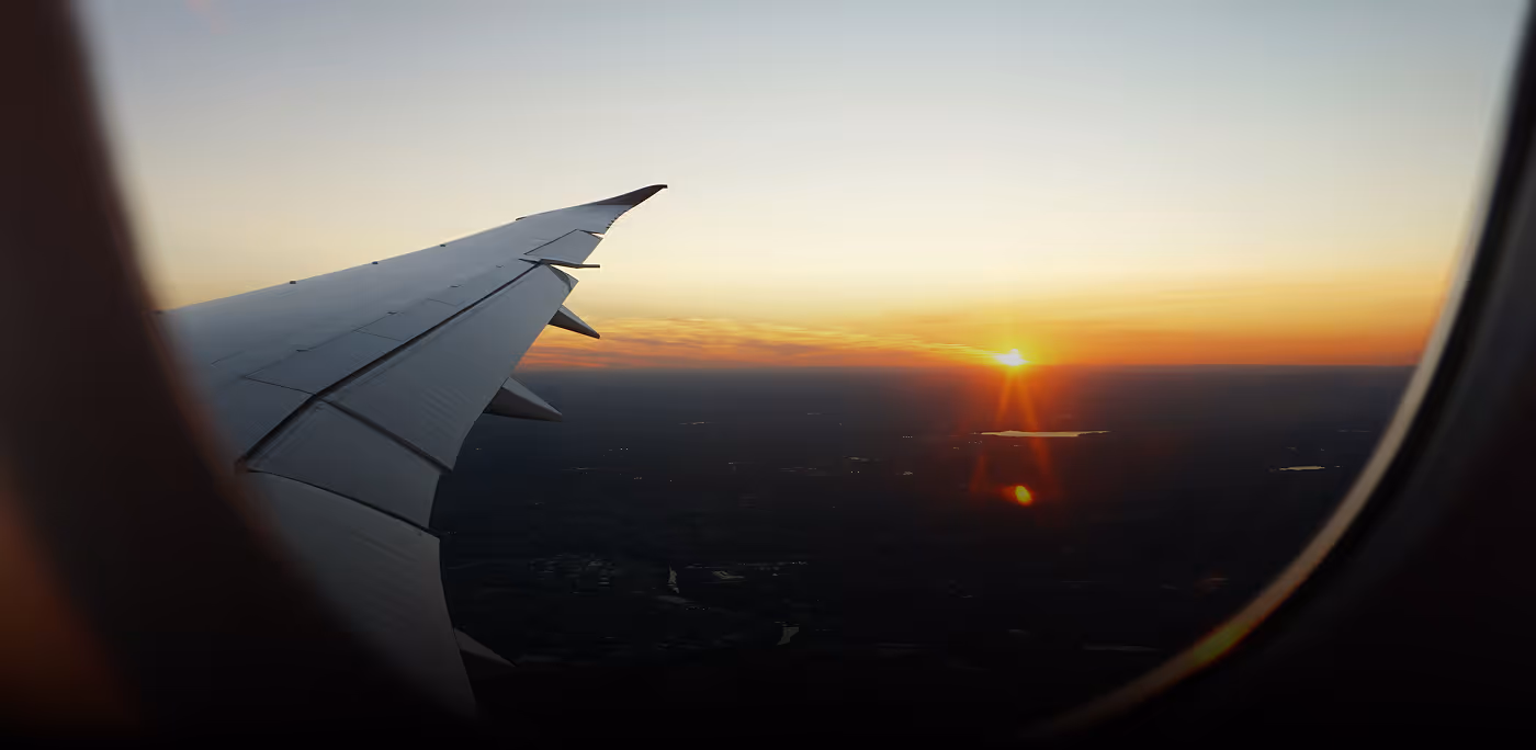 View of airplane wing during sunset seen through the aircraft window for Engine brand
