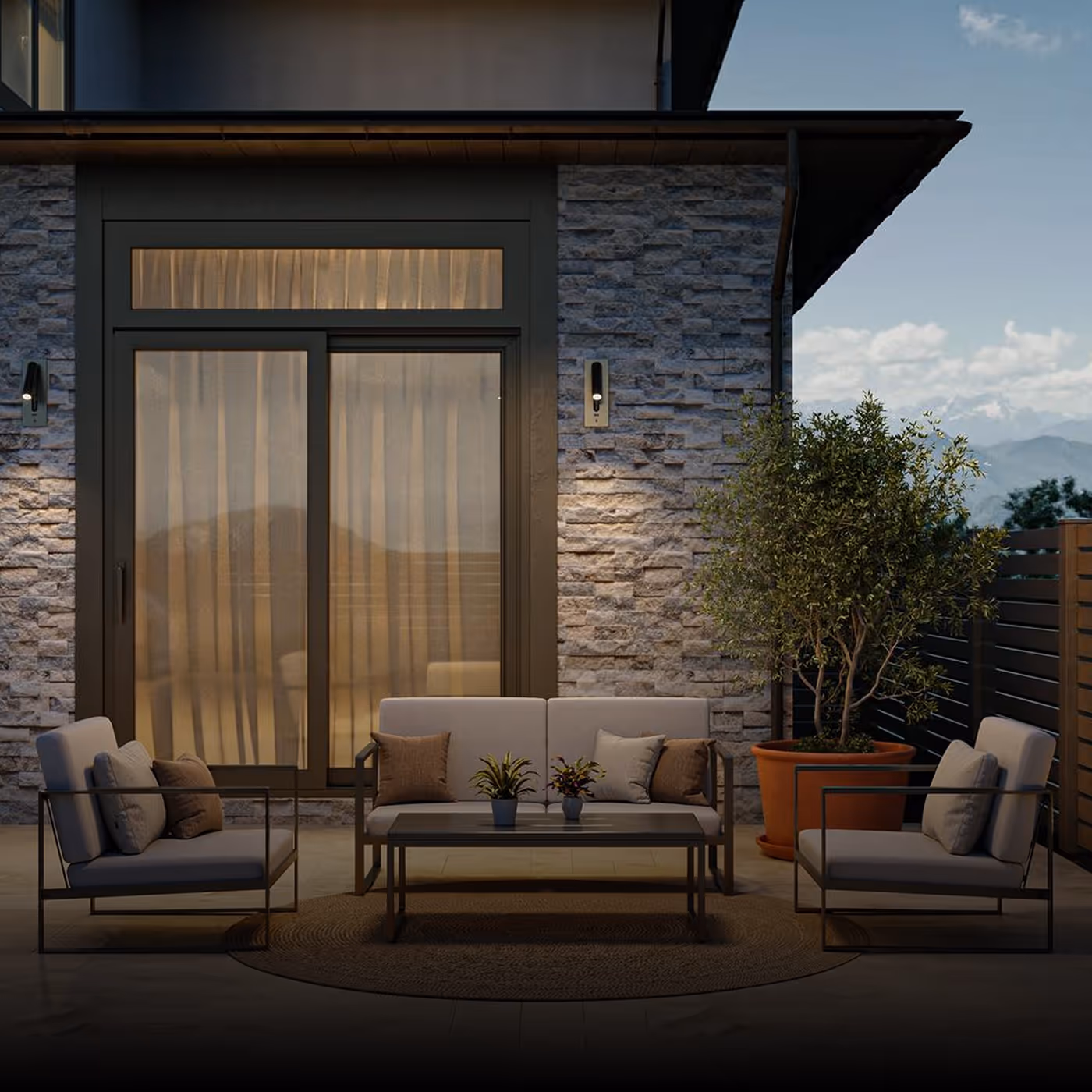 Outdoor patio with modern cushioned seating, a coffee table with small plants, stone wall, sliding glass door, and a large potted tree for Floor&Decor brand