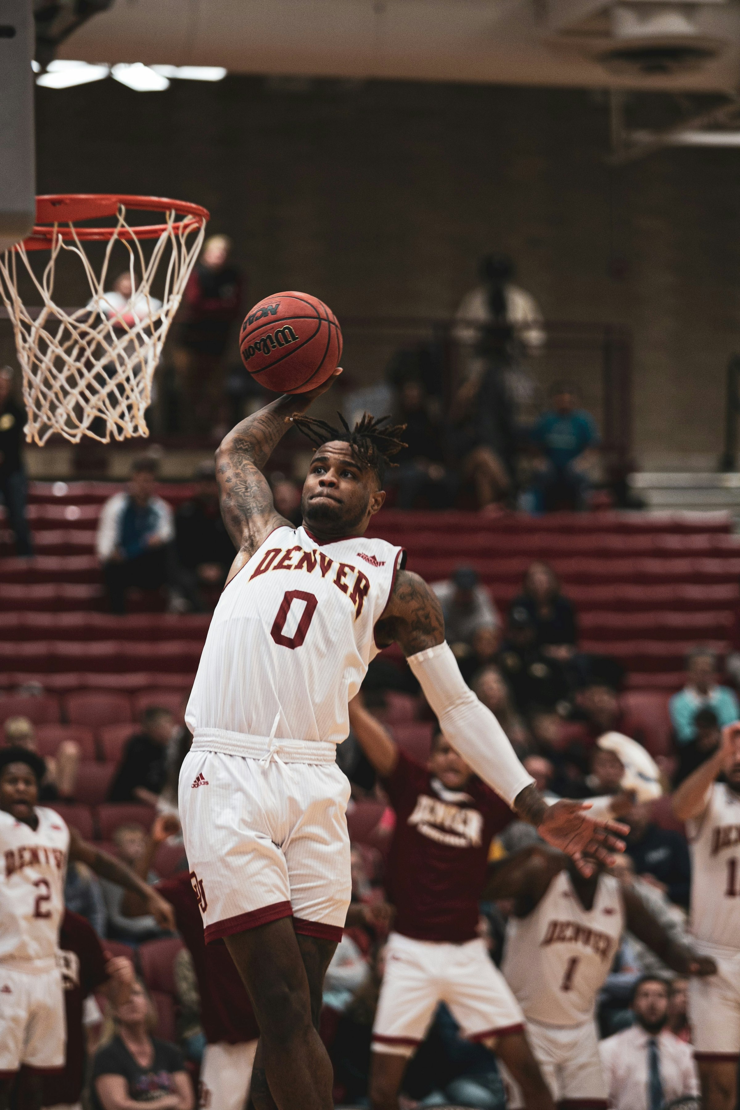 Basketball player elevating to dunk during a game