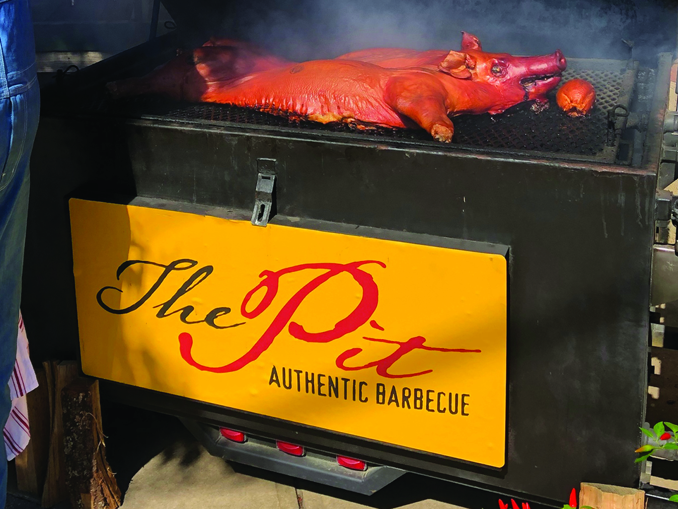 a whole hog cooking on a grill