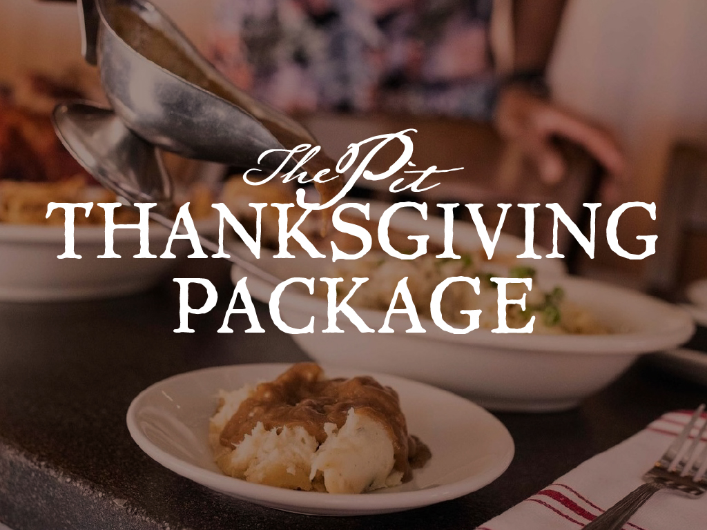 a person pouring gravy on mashed potatoes