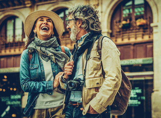 Retired couple laughing together while on vacation