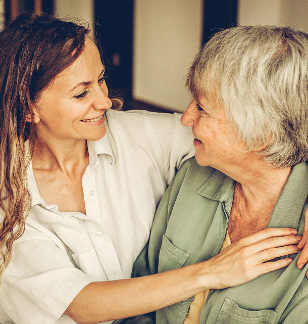 Retired woman and her daughter embracing