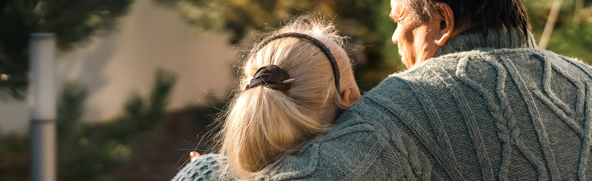 Retired couple embracing outside