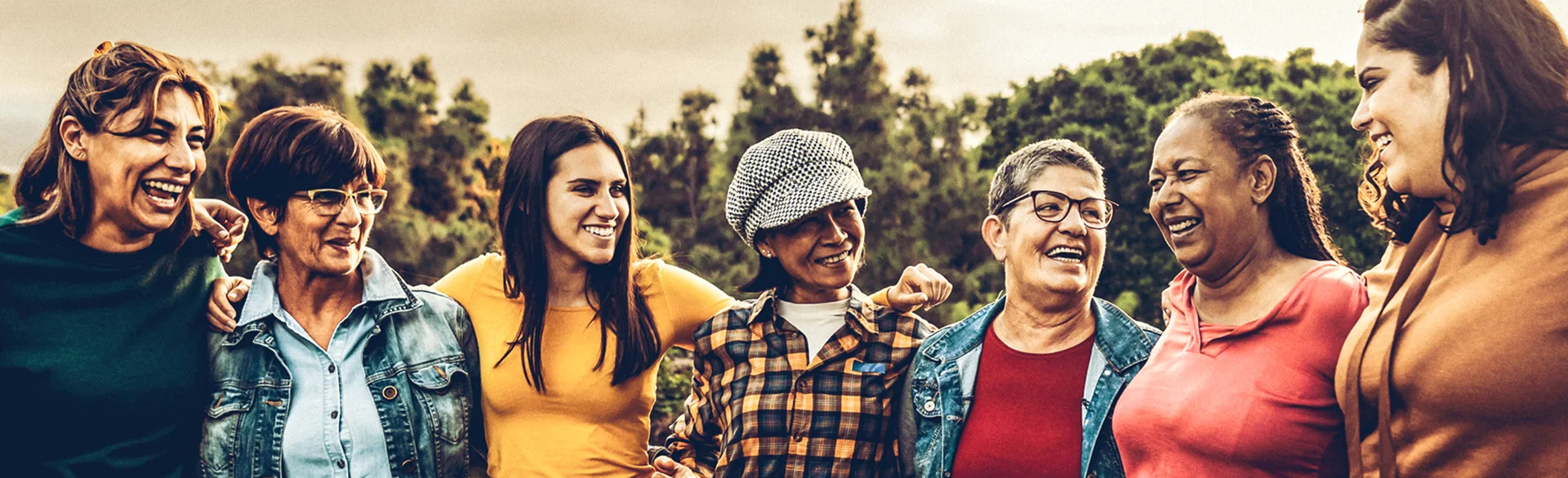 Retired women outdoors with younger generations of women