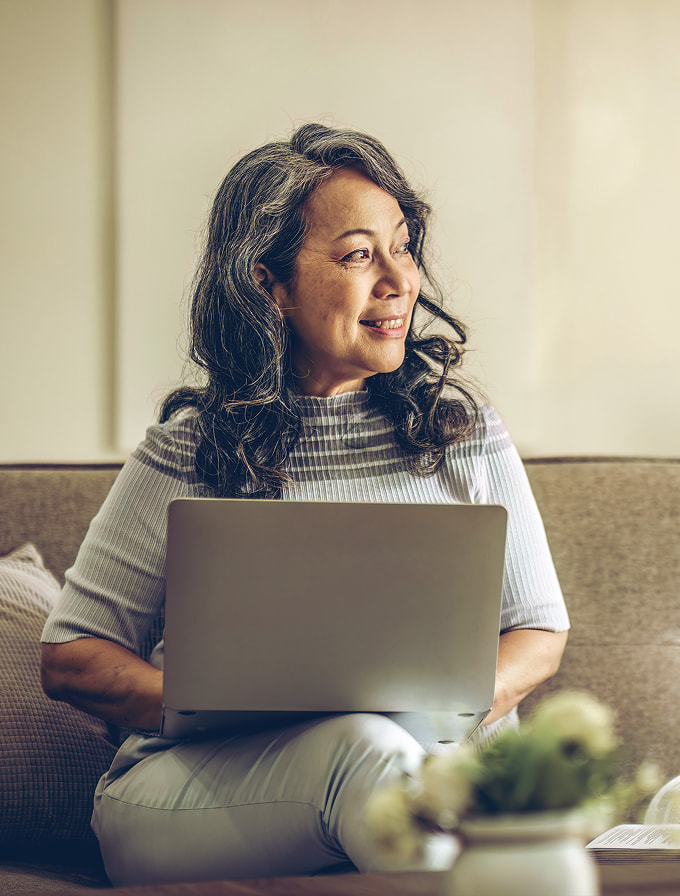 Retiree smiling while checking through their finances