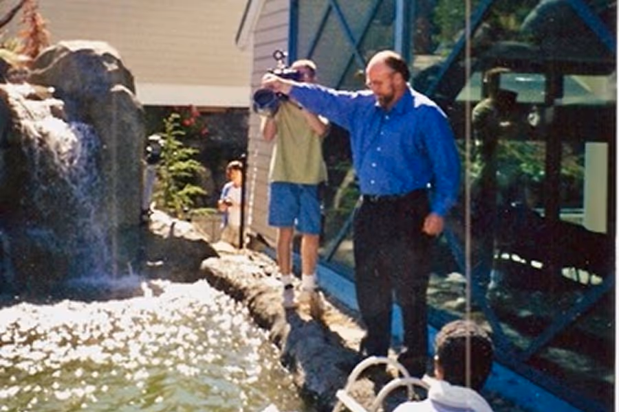 Former pastor Tim in front of the newly constructed waterfall