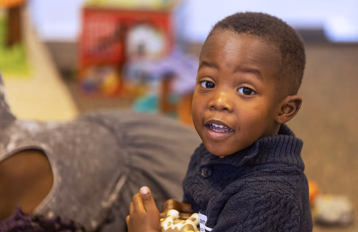 A child playing with a toy in the kids ministry at Red-Wood Falls Church
