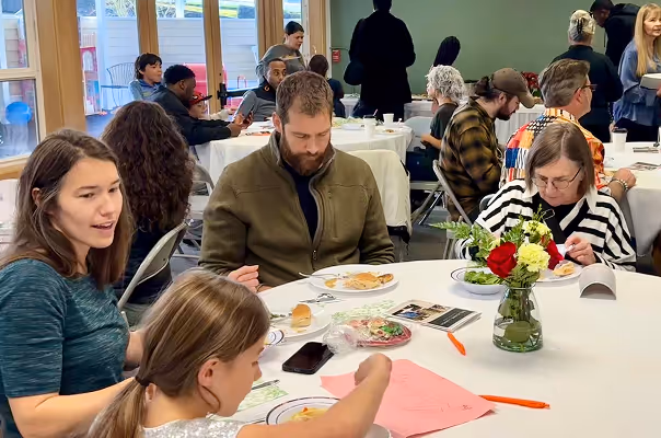 Multiple generations share a table during a welcome lunch at Red-Wood Falls