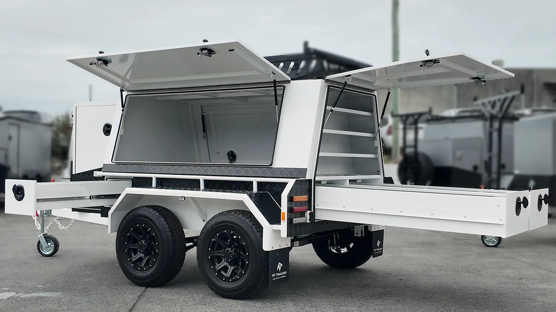 Essential Builders trailer with doors open, play our trailers in action video