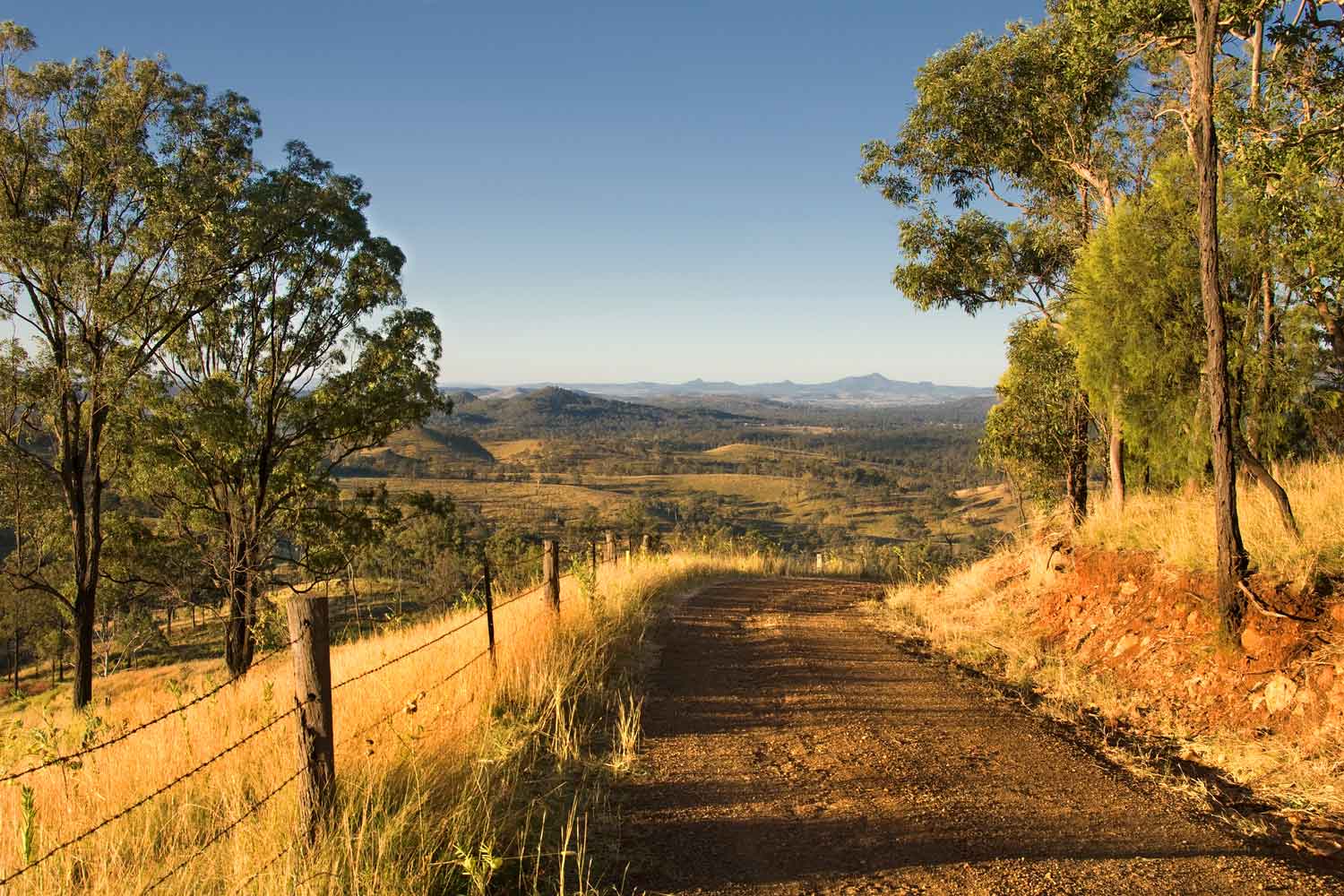 Landscape with a dirt road leading to a hillside