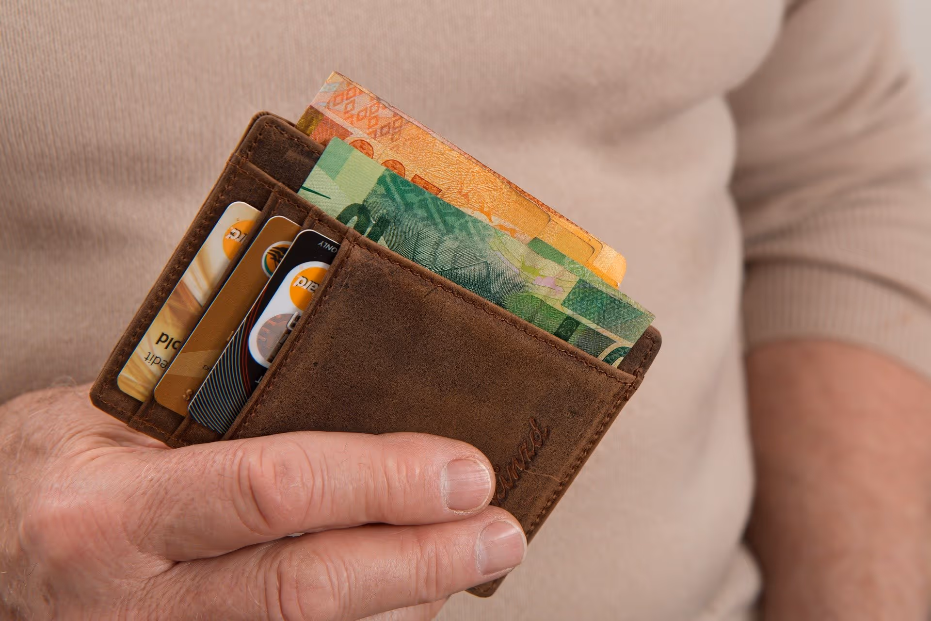 Person holing a wallet full of cach