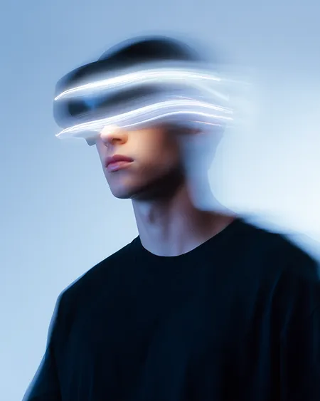 Person wearing a virtual reality headset with light trails obscuring the eyes against a blue background.