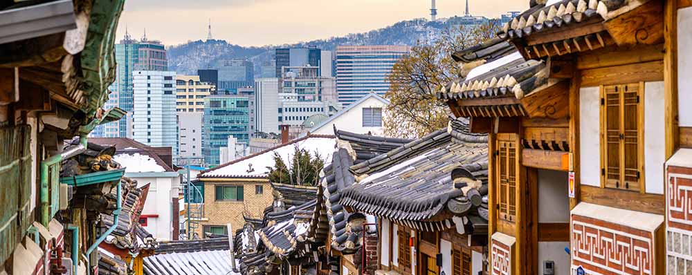 Vibrant Myeongdong shopping street or people wearing Hanbok at Gyeongbokgung Palace.