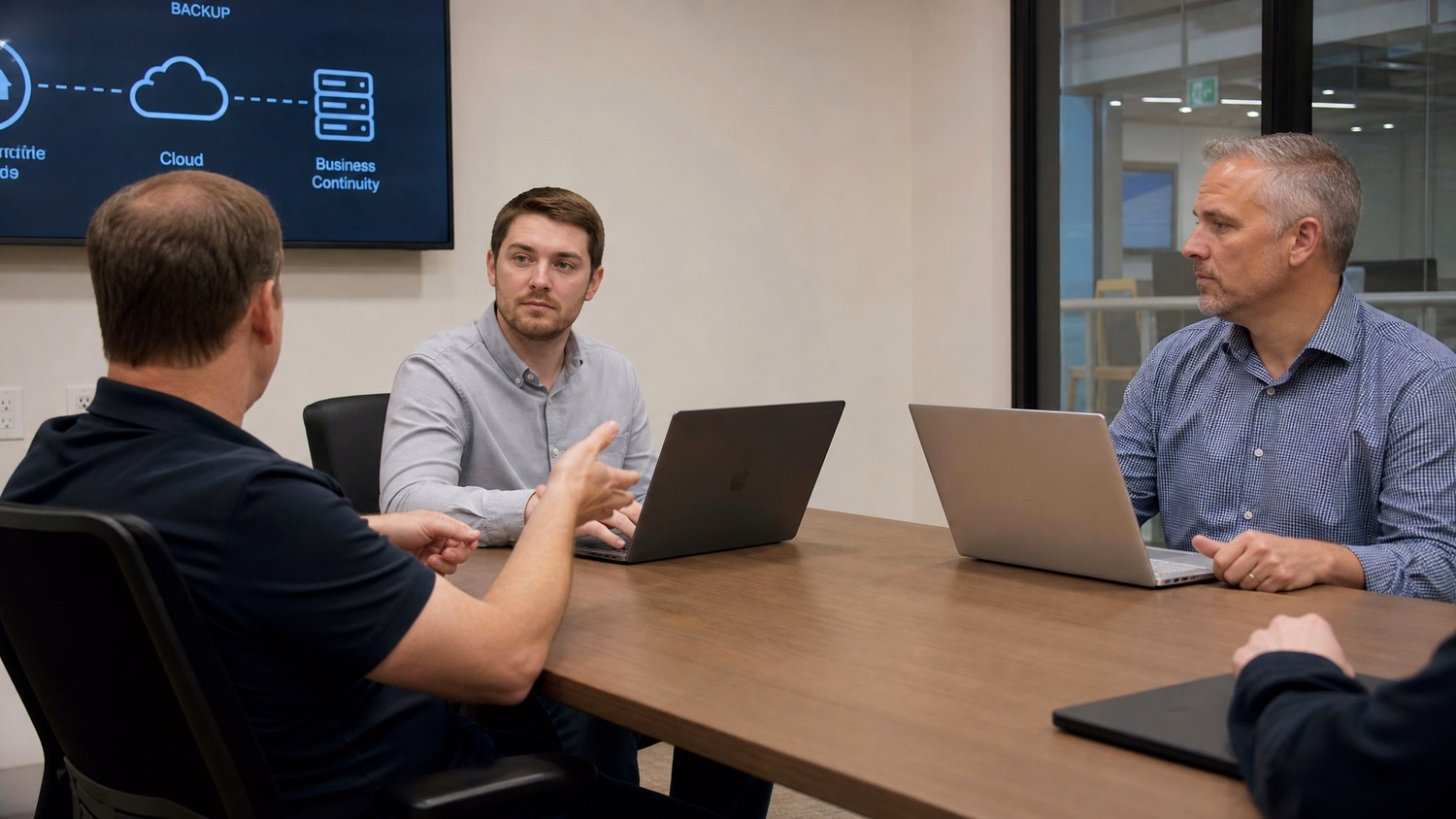 MEETING TABLE An IT professional two to four people seated around a meeting