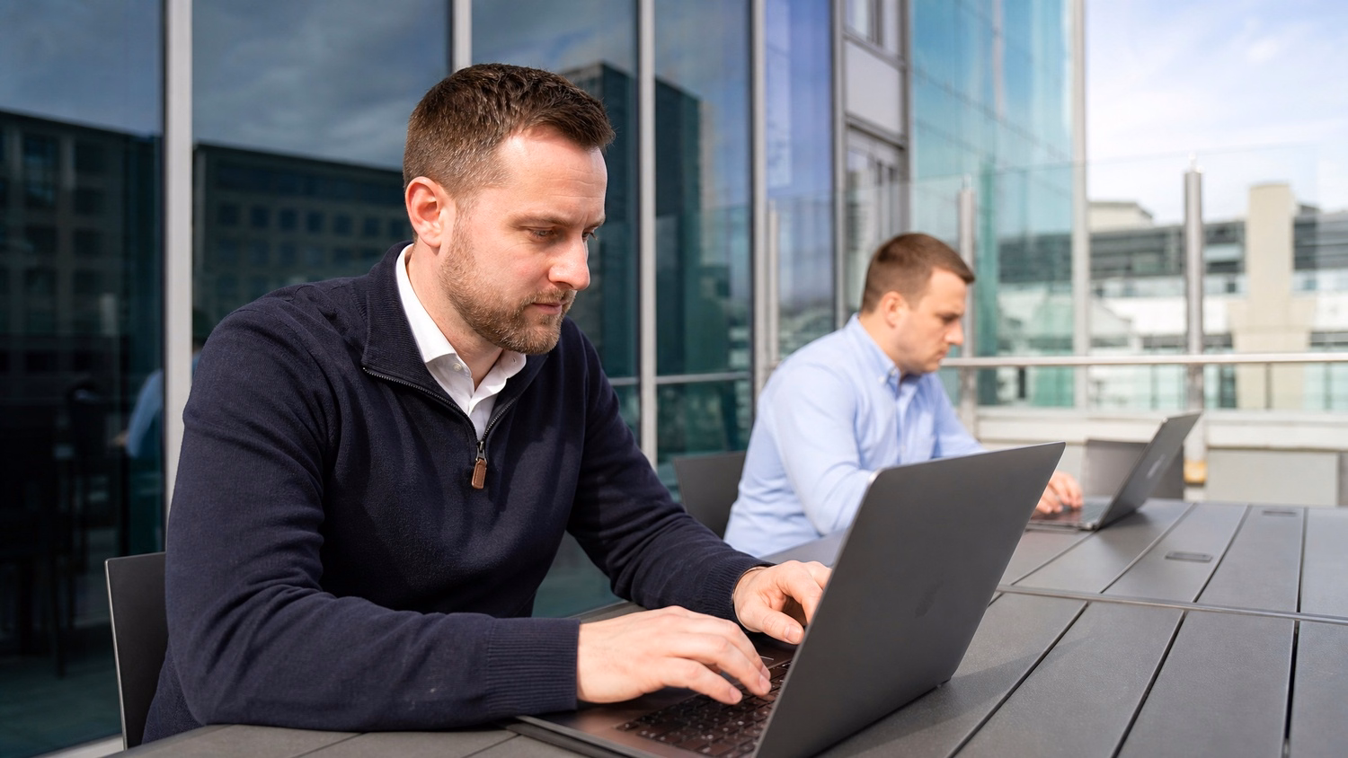 OUTDOOR TERRACE An IT professional one or two people working at a table on a