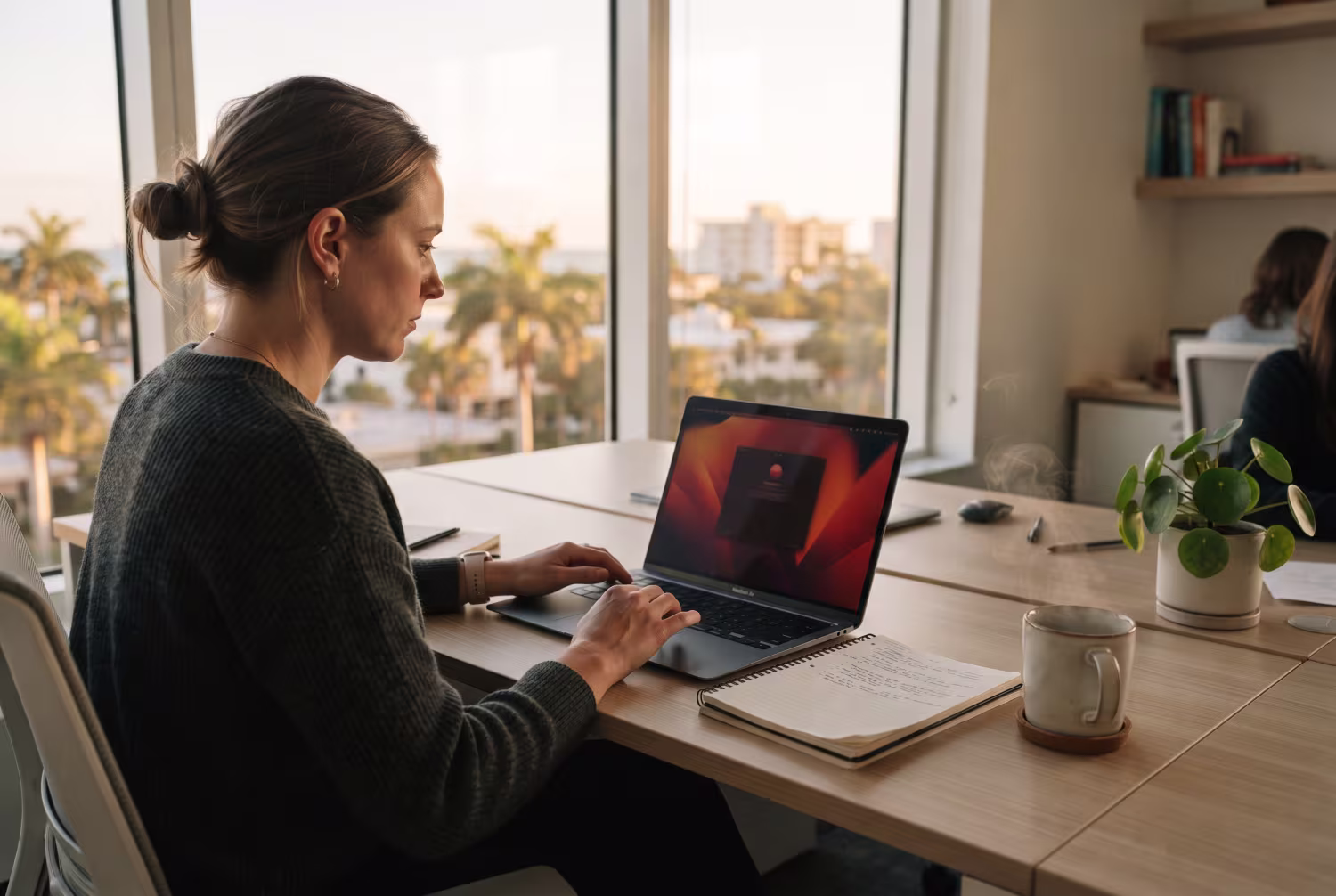Person at desk analyzing laptop for phishing prevention
