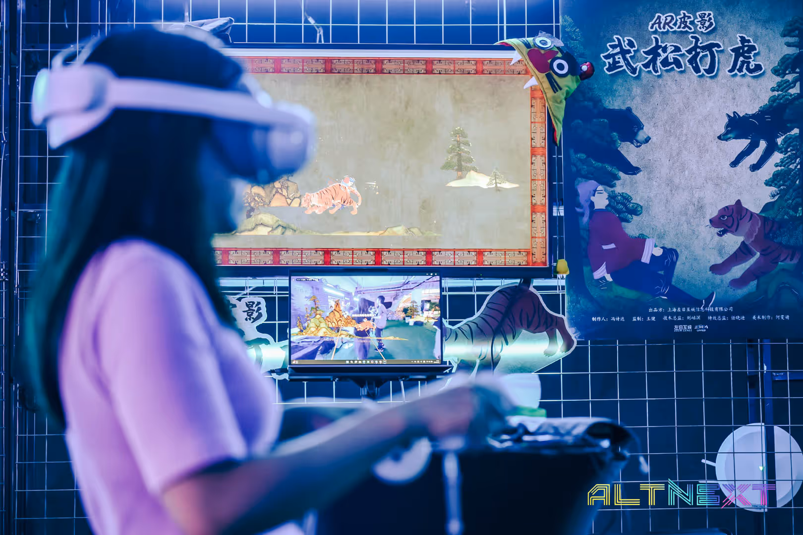 Person wearing VR headset interacting with an AR digital tiger display on a screen in a tech exhibition booth - at AltNext Season 1 (2025).