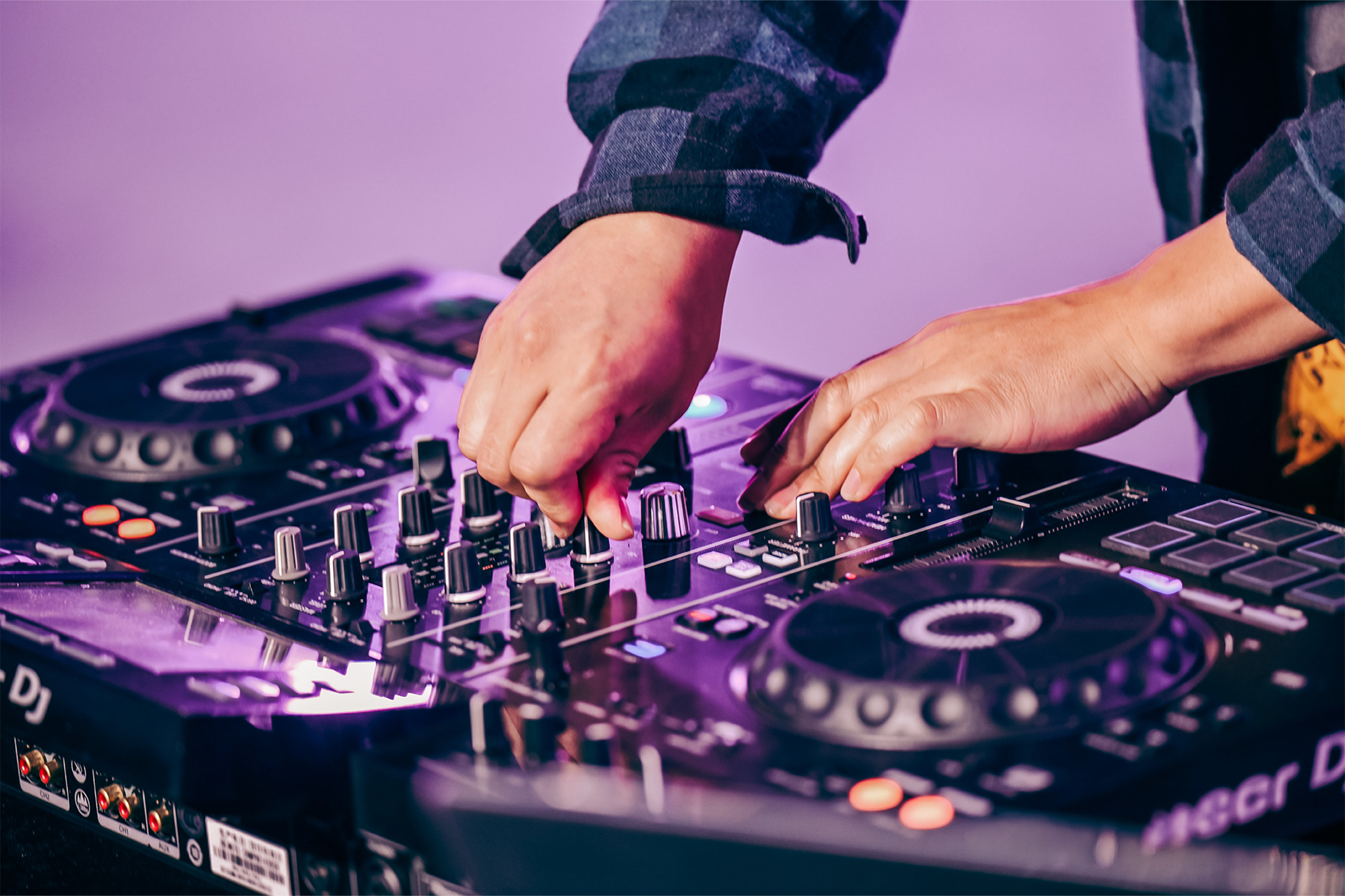 People socializing and exploring technology booths at a blue-lit indoor event or exhibition - at AltNext Edition 1 in 2025.