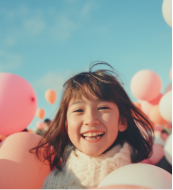 Woman in white dress sitting with arms resting on knees in soft lighting.