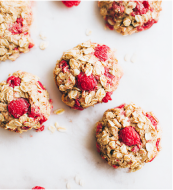 Young boy with outstretched arms outdoors with seagulls flying around him.