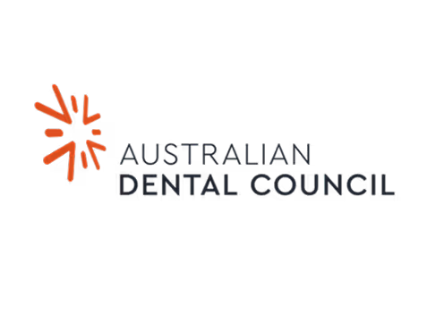 Logo of Australian Dental Council featuring an abstract orange star-like shape to the left of the text.