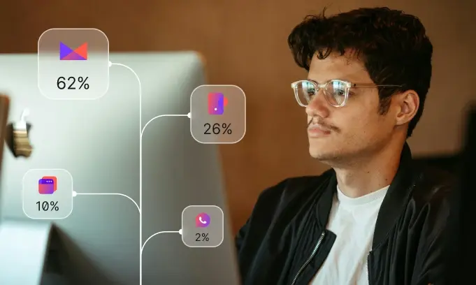 Man with glasses working on a laptop with overlay showing analytics percentages.