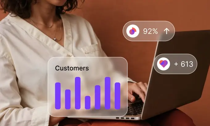 Person typing on laptop with floating data visuals showing customer stats and 92% growth.