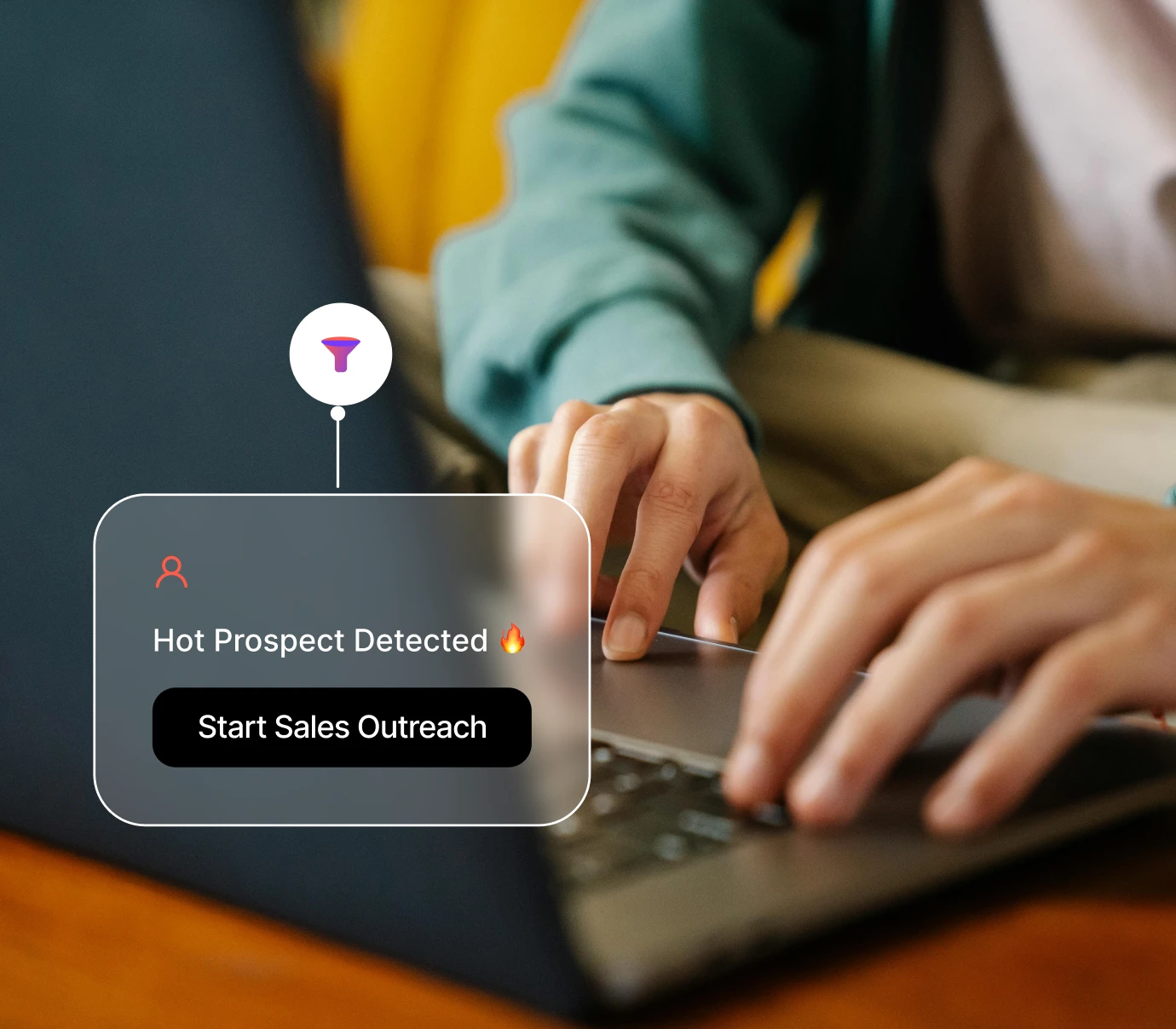 Hands typing on a laptop with an alert saying Hot Prospect Detected and Start Sales Outreach.