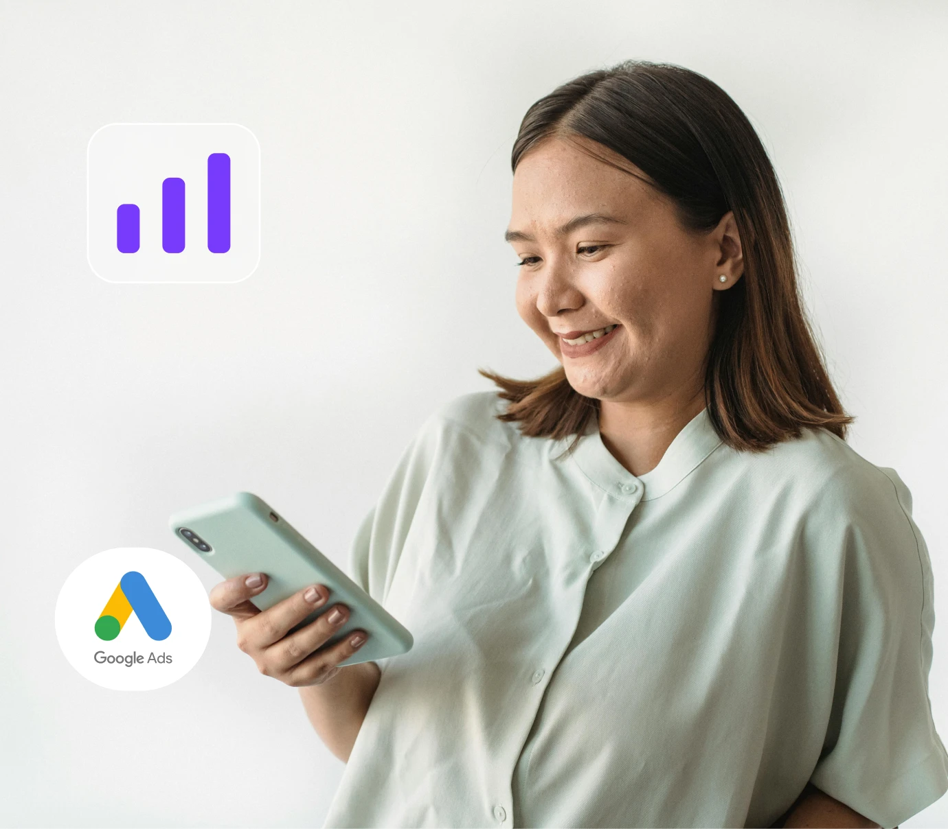Smiling woman looking at her smartphone with Google Ads and bar chart icons nearby.