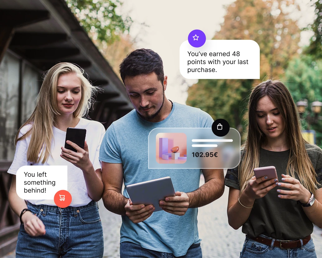 Three young adults outdoors using phones and tablet with shopping and rewards notifications displayed.