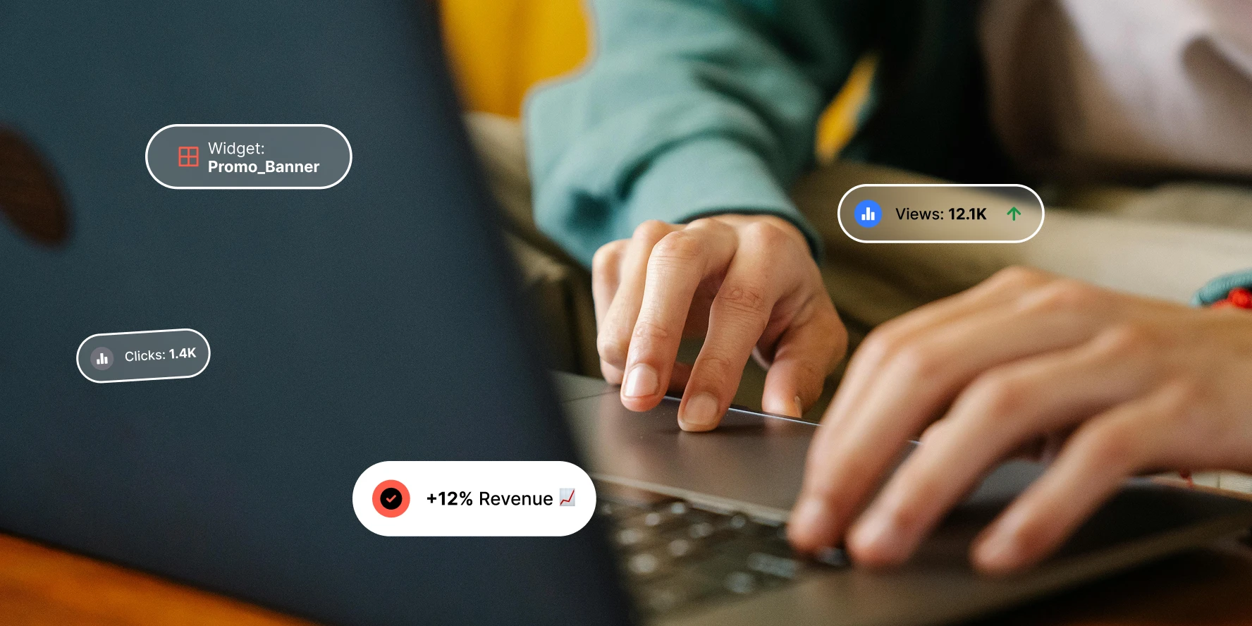 Close-up of hands typing on a laptop with performance tracking stats like views and revenue overlays.