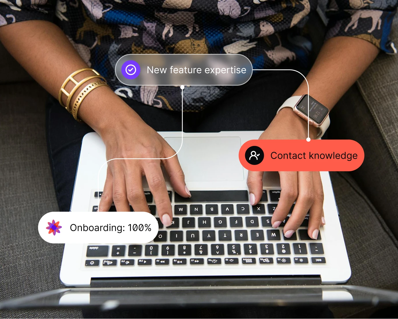 Hands typing on a laptop keyboard with icons labeled New feature, Contact knowledge, and Onboarding 100%.
