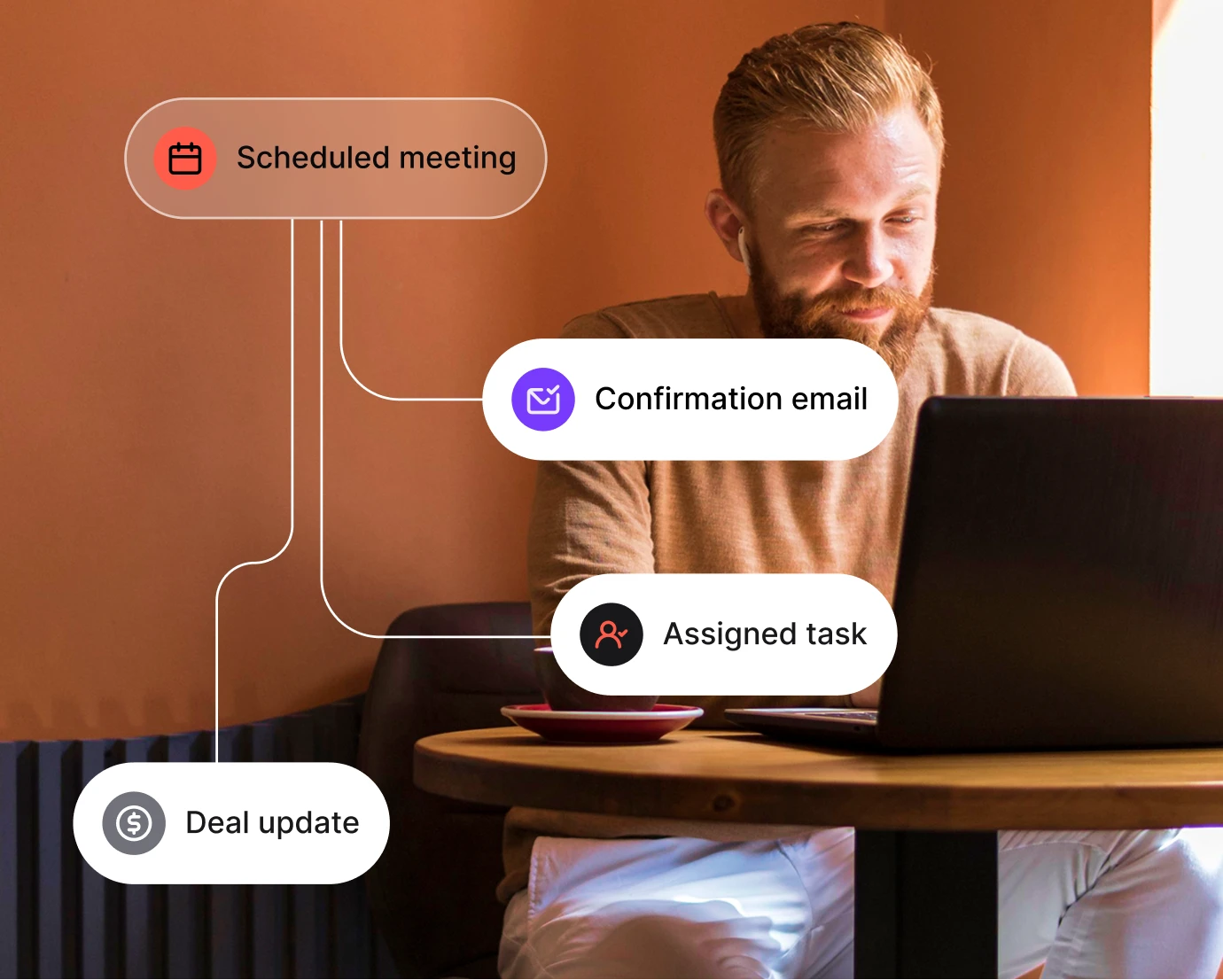 Man with beard working on laptop at a wooden table with icons for meeting, email, task, and deal update.