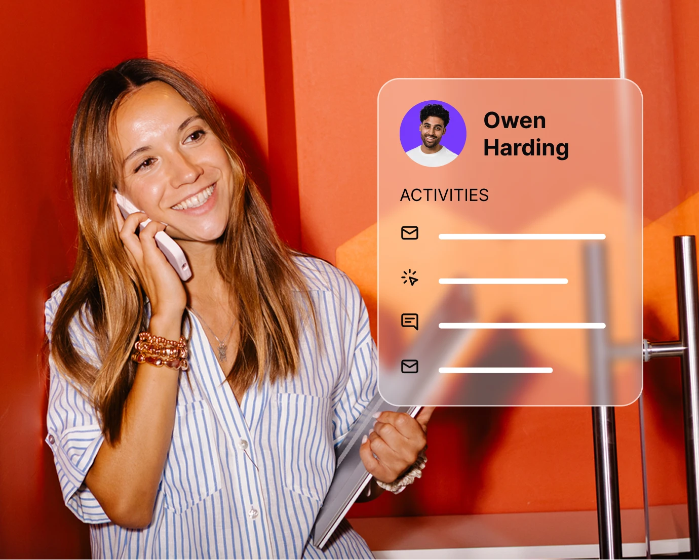 Smiling woman talks on phone holding folders with digital panel showing Owen Harding's activities.