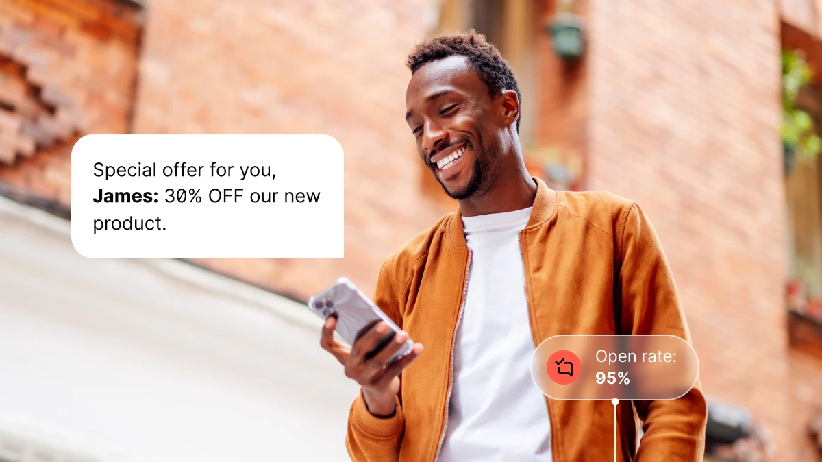 Smiling man in brown jacket checking phone with 30% discount message and 95% open rate.